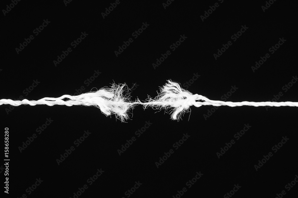 Tearing white the rope in the middle of the frame on the black