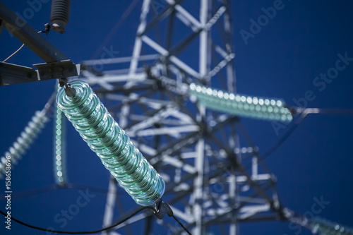 High voltage transmission power tower with glass insulators photo