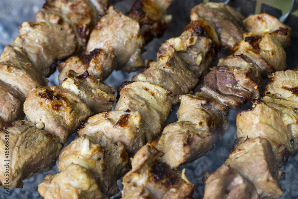 Marinated shashlik preparing on a barbecue grill over charcoal. Shashlik or Shish kebab popular in Eastern Europe. Shashlyk (skewered meat) was originally made of lamb. Roast Beef Kebabs On BBQ Grill Marinated shashlik preparing on a barbecue grill over charcoal. Shashlik or Shish kebab popular in Eastern Europe. Shashlyk (skewered meat) was originally made of lamb. Roast Beef Kebabs On BBQ Grill