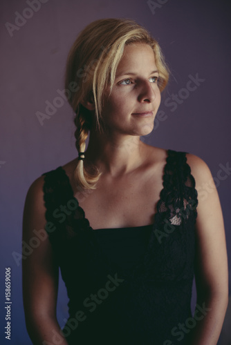 Cute young adult woman portrait by the window