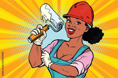 Construction worker with roller for paint. Woman professional