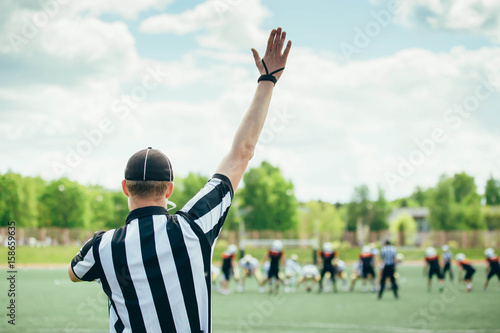 American Football played by young men with game official linesman referee