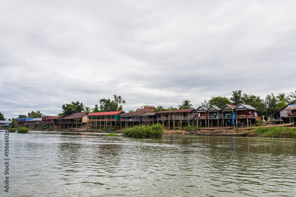 Old wooden houses along the Mekong river in Laos, Dondet city.
