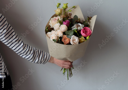 Bouqet in a craft paper in a hand