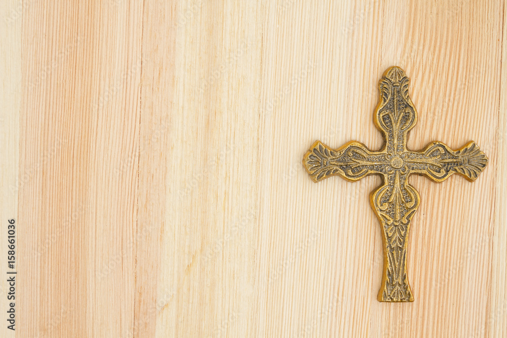 Cross on wood background