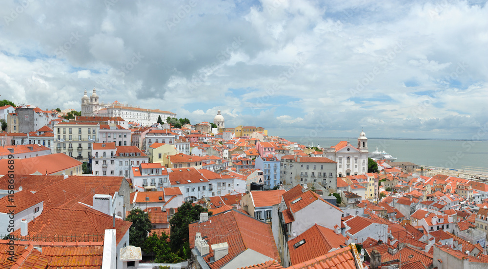 Fototapeta premium View of Alfama, and Monastery of Sao Vicente de Fora on sunny cloudy day, Lisbon Portugal