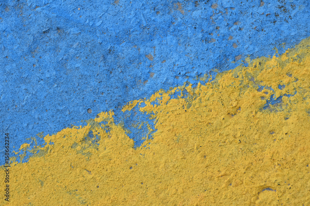 Blue and yellow painted concrete wall texture Blue and yellow painted concrete wall texture