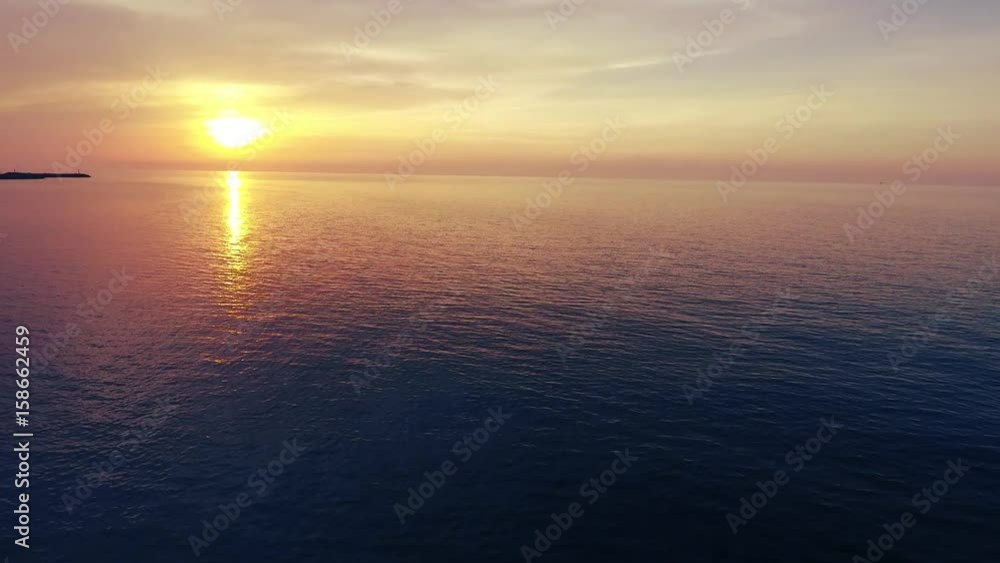 Shot of a beautiful summer sunset at the beach. Sunset at sea drone footage Shot of a beautiful summer sunset at the beach. Sunset at sea drone footage