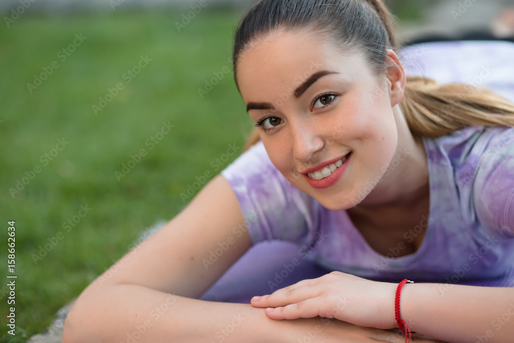 Woman on a sportive mat lying relaxing outdoor Woman on a sportive mat lying relaxing outdoor