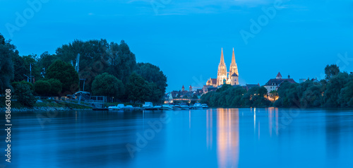 Regensburg mit Jachthafen an der Donau und Blick zum Dom St. Peter zur blauen Stunde photo