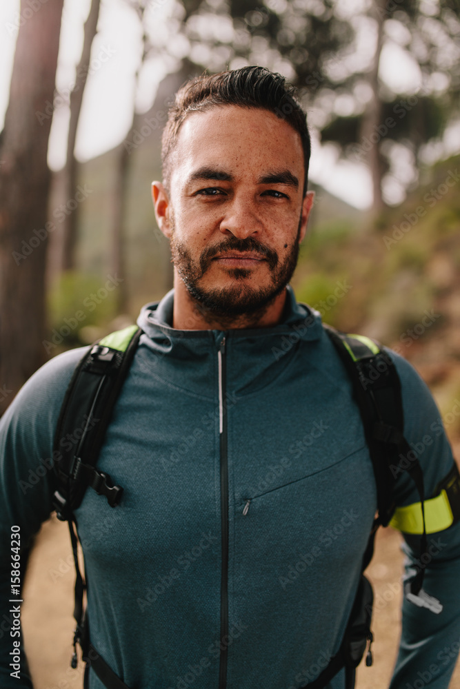 Portrait of young male athlete standing outdoors