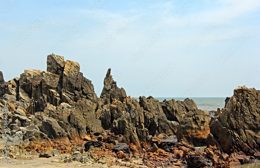 Rugged, rocky, spiky, and sculpture type coastline of Arambol coast in Goa, India