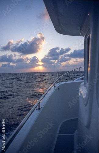 Sunrise off large yacht