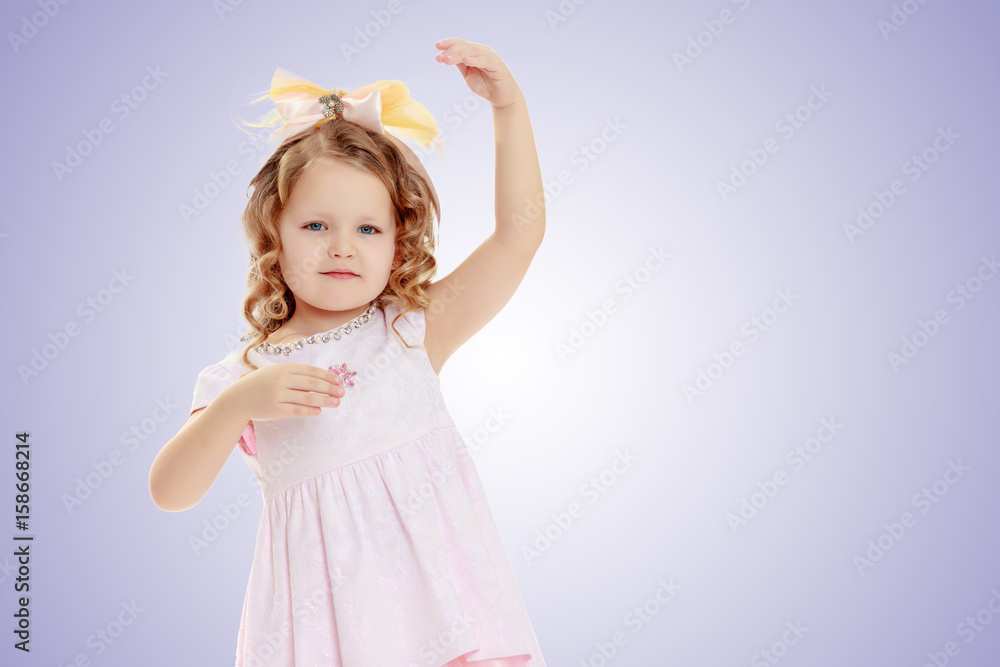 Girl shows the doll. Girl shows the doll.