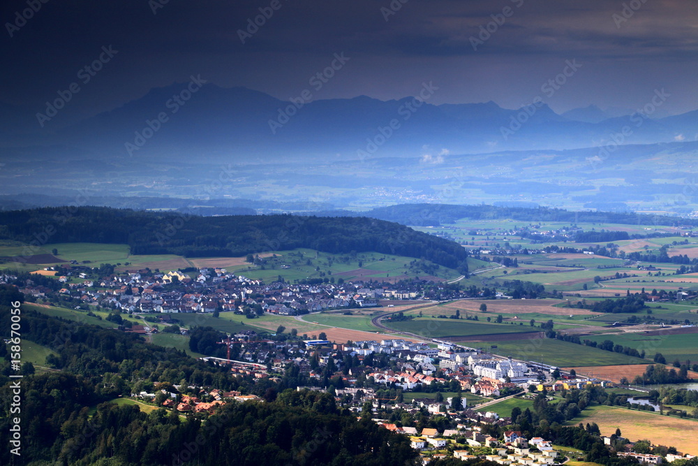 Farmland, forests and villages of Bonstetten and Wettswil am Albis with Pilatus mountain in the background after a summer rain, from Uetliberg, Zurich, Switzerland, Europe