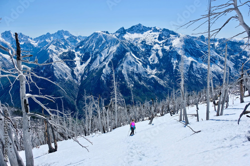 Woman  walking up in mountains.  Icicle Ridge in Central Cascade Mountains. Leavenworth. Seattle. Washington. United States. photo