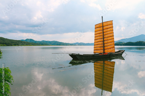 Old wooden sailing boat with river at Dumulmeori in Yangpyeong, Korea photo