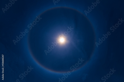 sky sun halo phenomenon in blue dark blue sky. photo