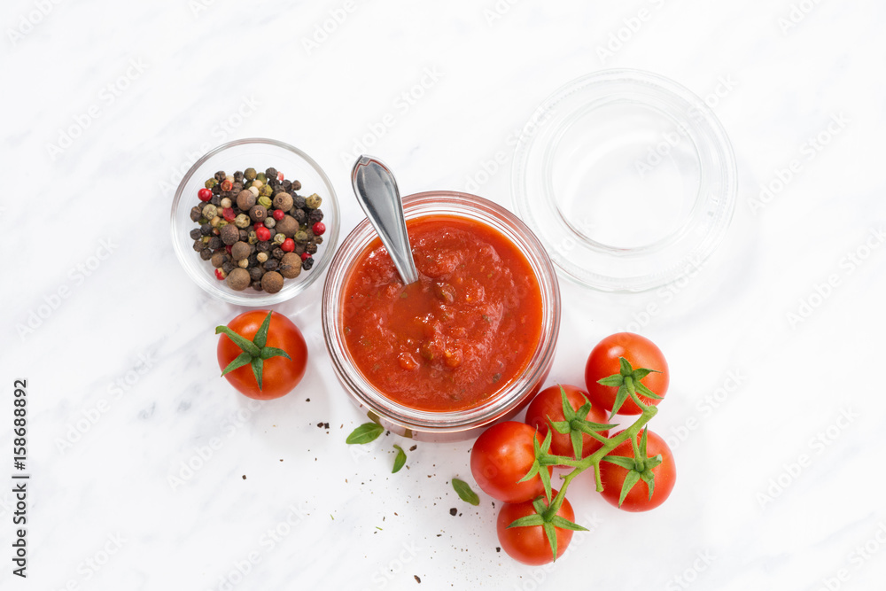 tomato sauce in a glass jar and white background, top view tomato sauce in a glass jar and white background, top view