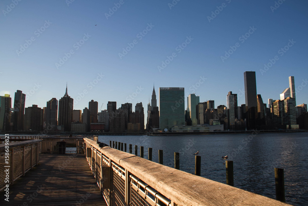 Pier and Manhattan city under the shade and sunset sky, New York Pier and Manhattan city under the shade and sunset sky, New York
