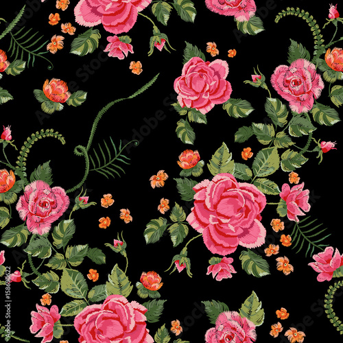 Embroidery traditional seamless pattern with red roses and forget me not. Vector embroidered floral bouquet template with flowers for clothing design. © lxby60