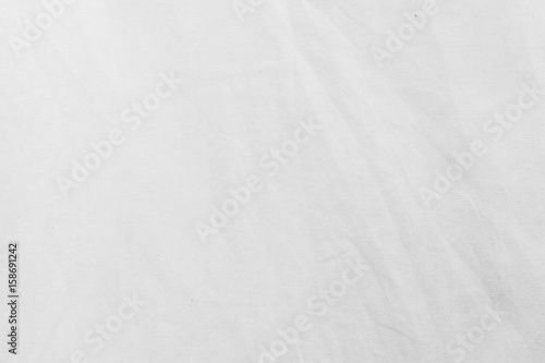 White fabric cloth texture with creased background. © topzafoto