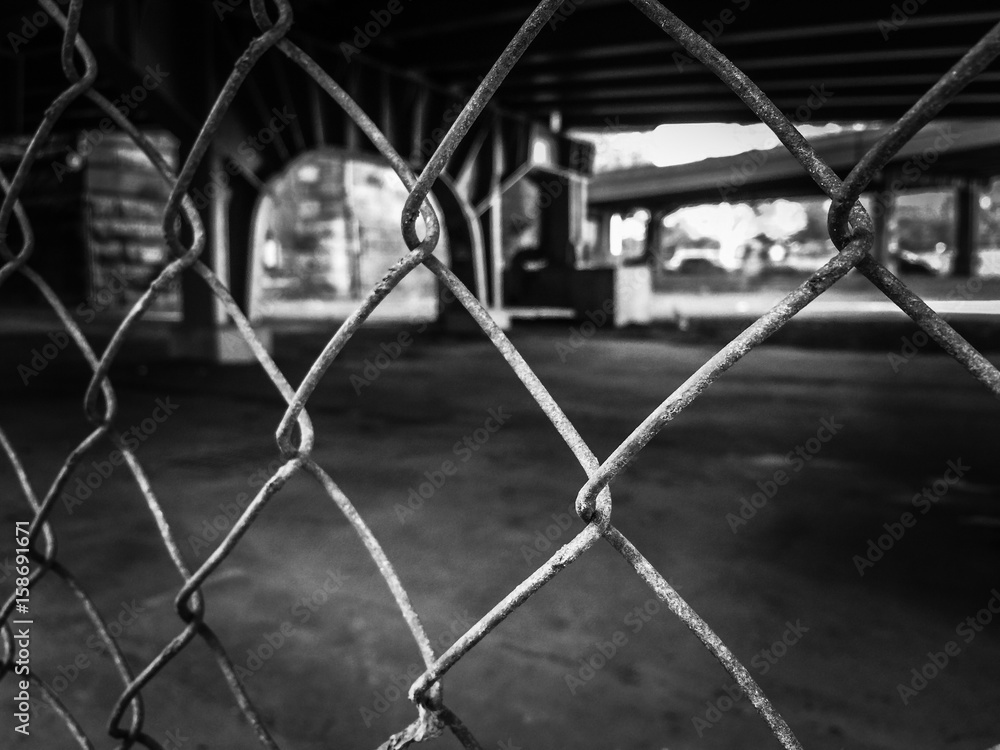 Steel net and blurred city background in black and white Steel net and blurred city background in black and white