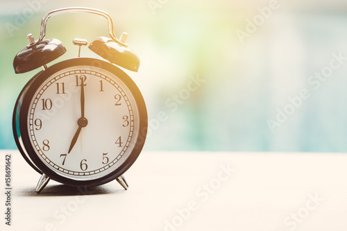 7 o'clock retro clock at the swimming pool outdoor relax time holiday time concept.