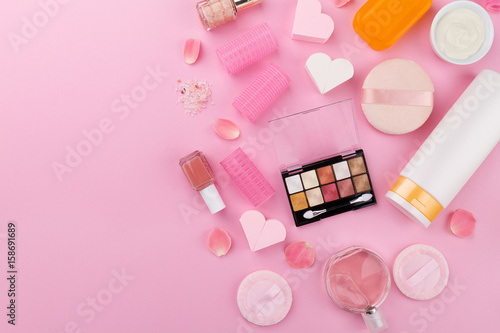 Beauty Spa Feminine Concept. Different Make Up Beauty Care Essentials Cosmetics on Flat Lay Pink Background. Top View. Copy Space.