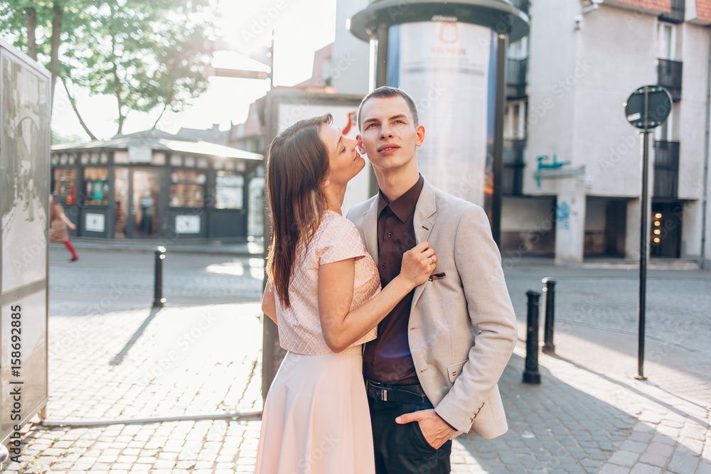 beautiful couple kissing on the street in summer