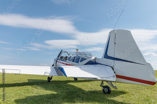 Фотография Two seat single engine civil utility aircraft, white small plane, red and blue s