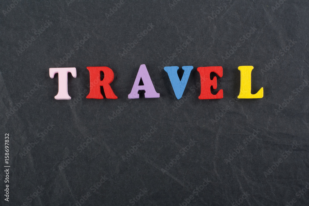 TRAVEL word on black board background composed from colorful abc alphabet block wooden letters, copy space for ad text. Learning english concept. TRAVEL word on black board background composed from colorful abc alphabet block wooden letters, copy space for ad text. Learning english concept.