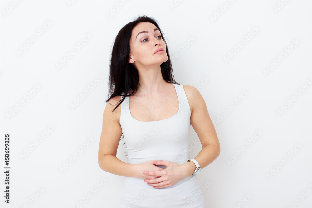 Woman with pain is holding her aching belly Woman with pain is holding her aching belly
