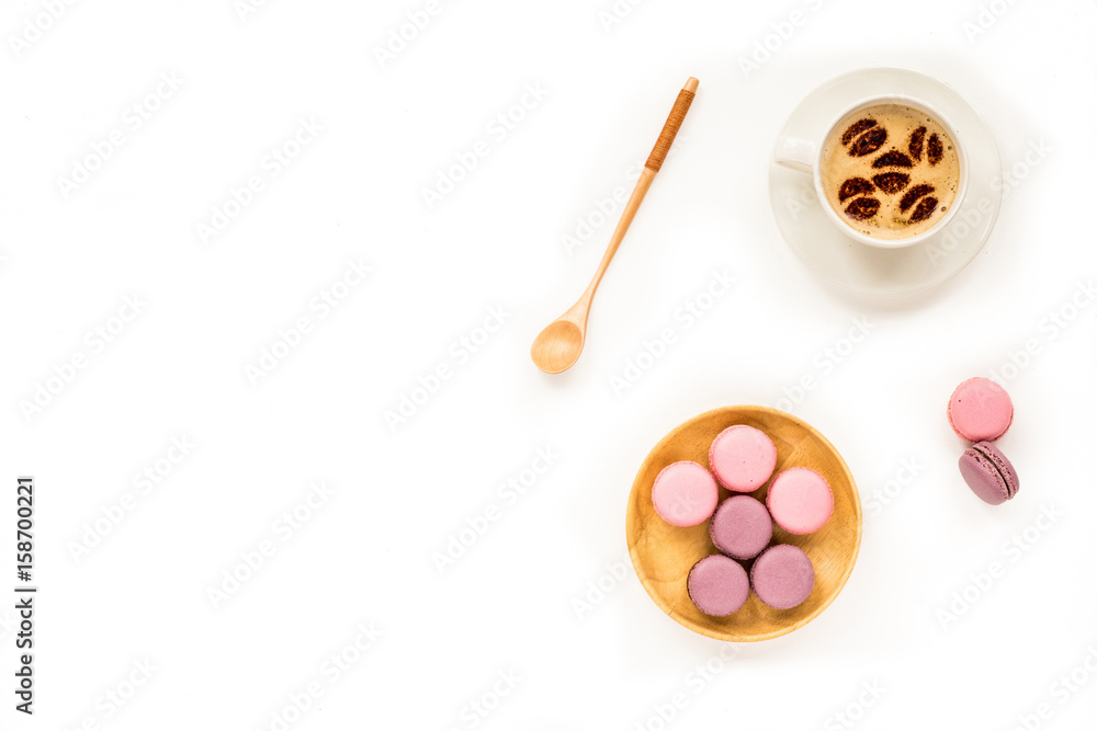 Composition with macaroon and cup of cooffee on white background. Flat lay, top view, copy space Composition with macaroon and cup of cooffee on white background. Flat lay, top view, copy space
