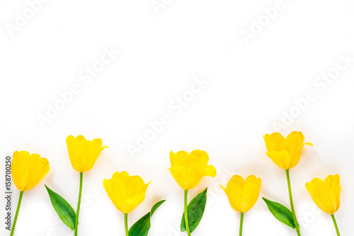 Spring flowers. Composition with yellow tulip flowers on white background. Flat lay, top view, copy space.
