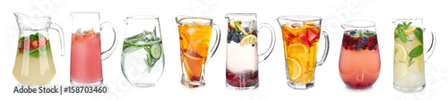 Different drinks in glass jugs on white background. Ideas for summer cocktails