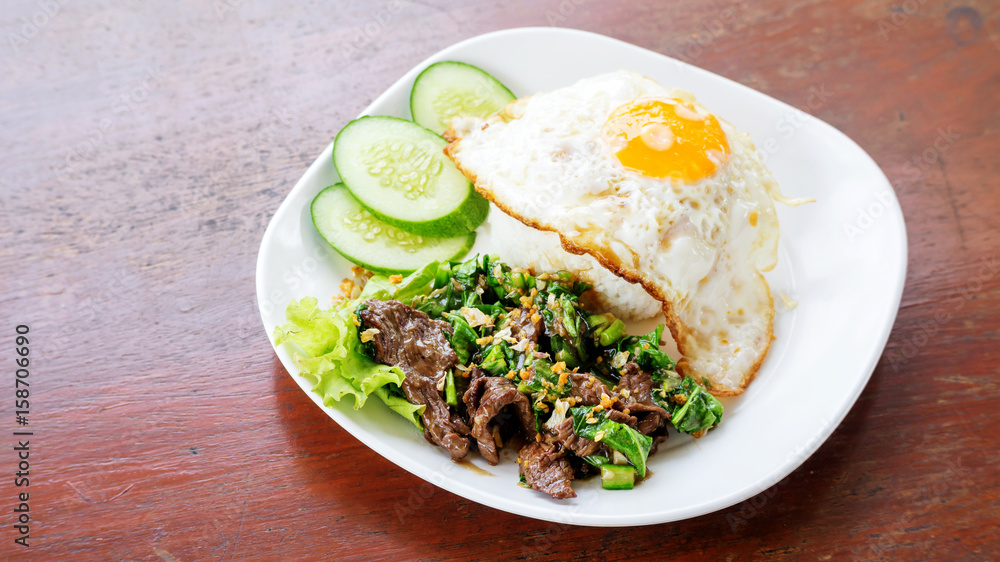 Stir fried beef and kale with jasmine rice and fried egg, Thai food.