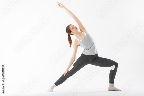 Young woman exercise yoga supported headstand