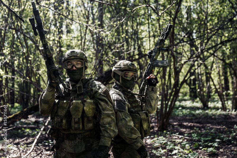 Soldiers with weapons in forest