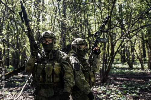 Soldiers with weapons in forest