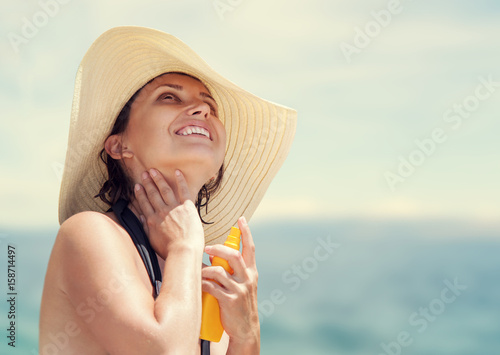 Woman in big straw hat enjoy with summer sun