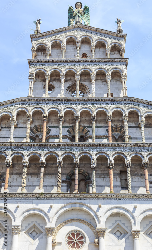 Richly decorated facade of Basilica San Michele in Foro, Roman Catholic church in Lucca, Tuscany, central Italy, built over ancient Roman forum