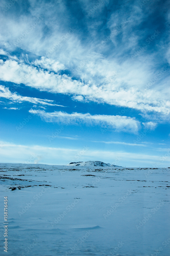 White cloud, blue sky, snowy ground, Iceland