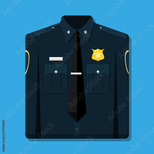 Folded blue policeman uniform with badge.
