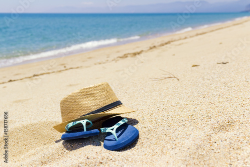 sand flip-flops and boater, relaxation on beach, Sardinia Italy, 
