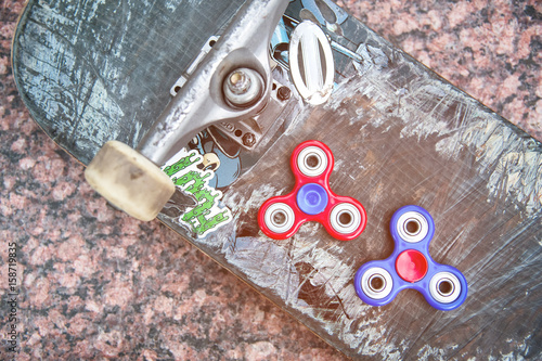 Close-up of skateboard and spinners photo