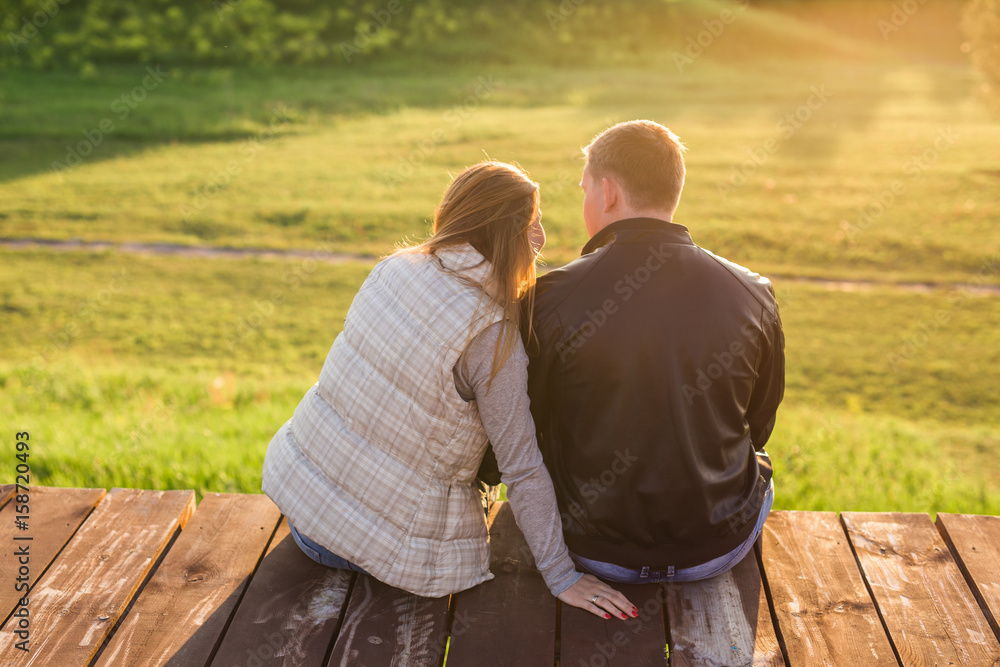 couple hugging on a pier in nature back view couple hugging on a pier in nature back view