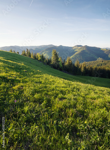 Mountain pasture and clear sky. Beautiful natural landscape in the summer time