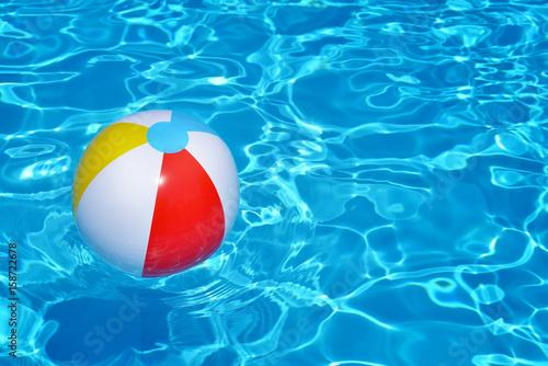 Fototapeta Naklejka Na Ścianę i Meble -  Colorful inflatable ball floating in swimming pool