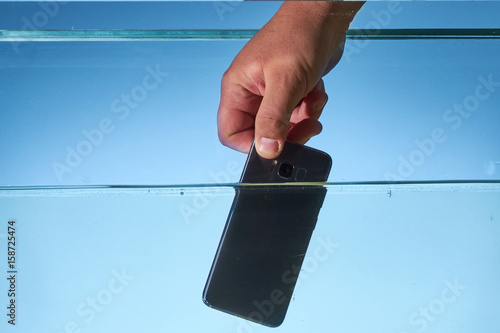Man holding Galaxy S8 in water photo